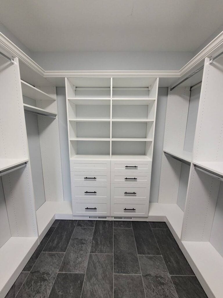 Closet organization with custom shelving and drawers.