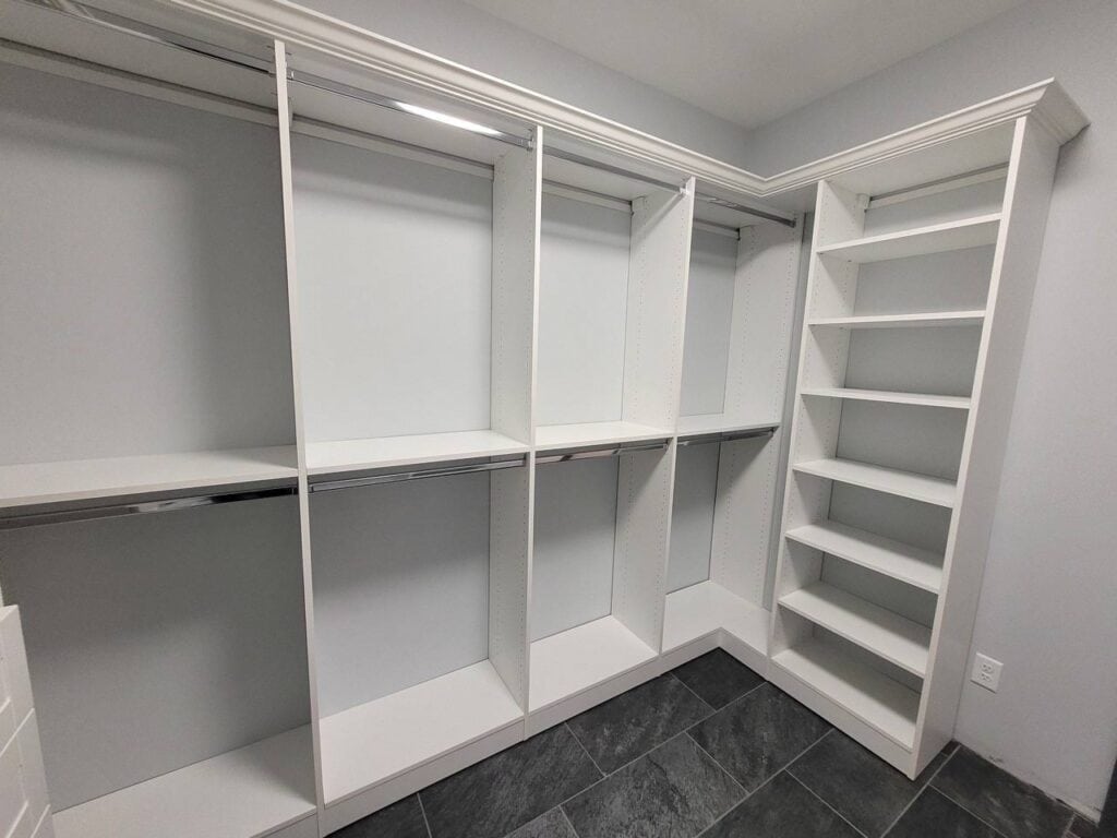 Custom walk-in closet with multiple shelves and hanging space.