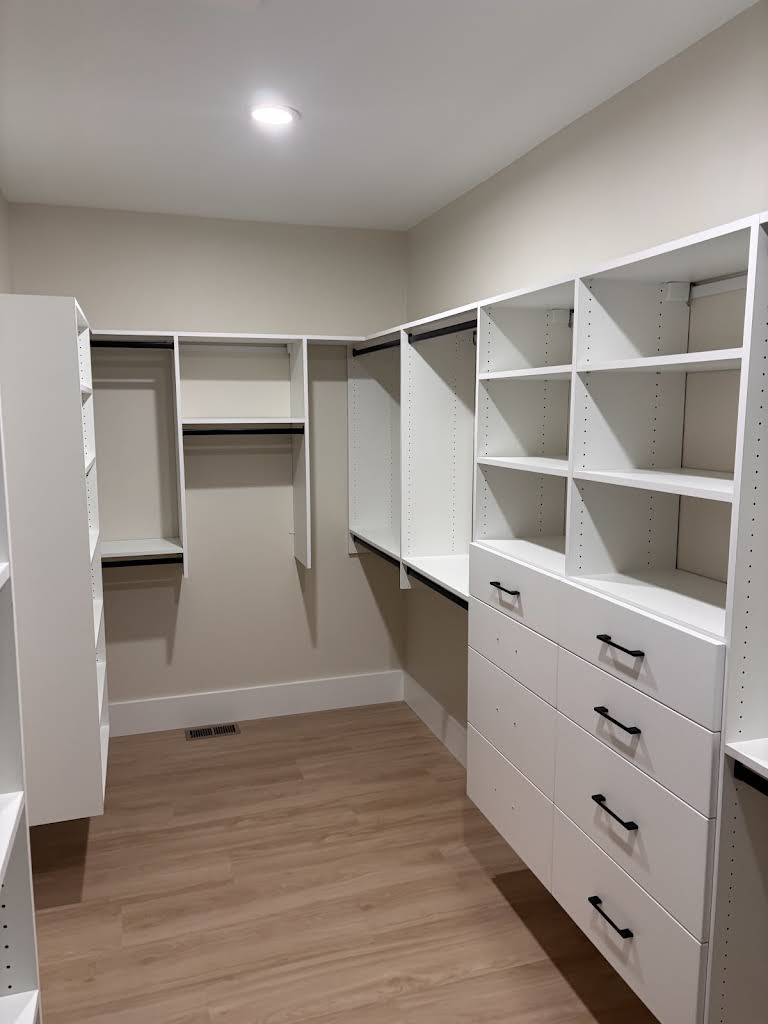 Enhanced closet organization with custom shelving and drawers.