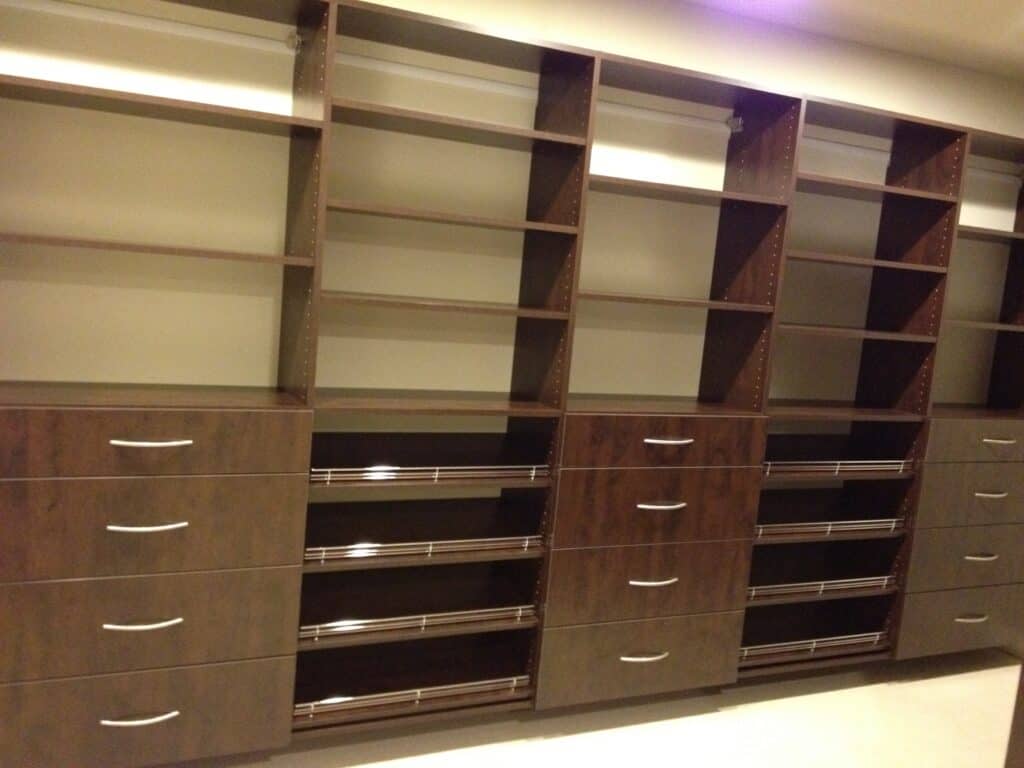 Custom closet storage units with multiple shelves and drawers for organized wardrobe solutions.