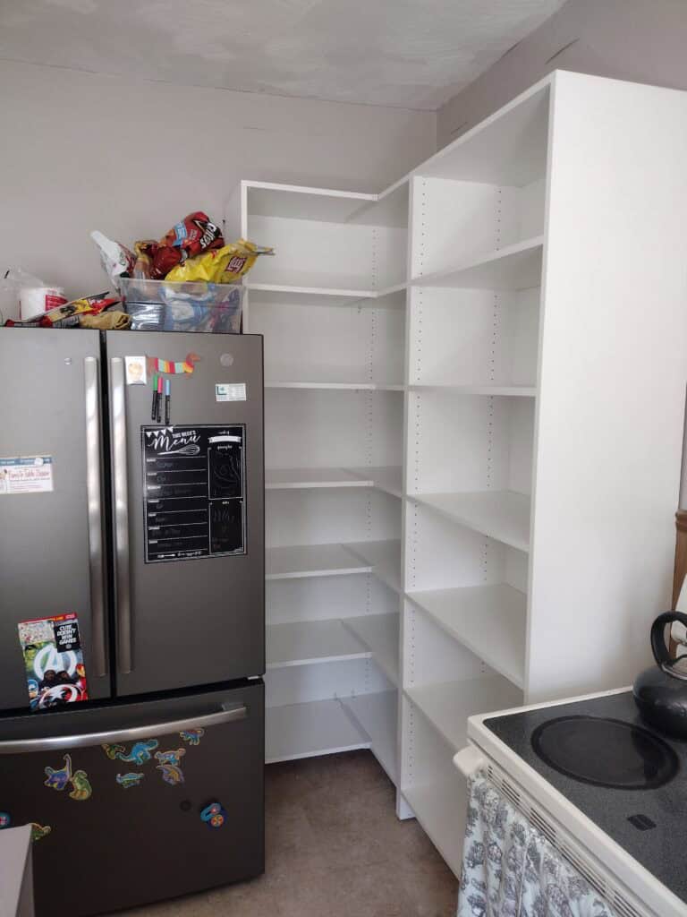 White kitchen pantry shelving unit for organized storage.