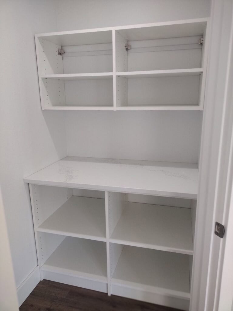 Custom white closet shelving and storage unit for organized wardrobe space.
