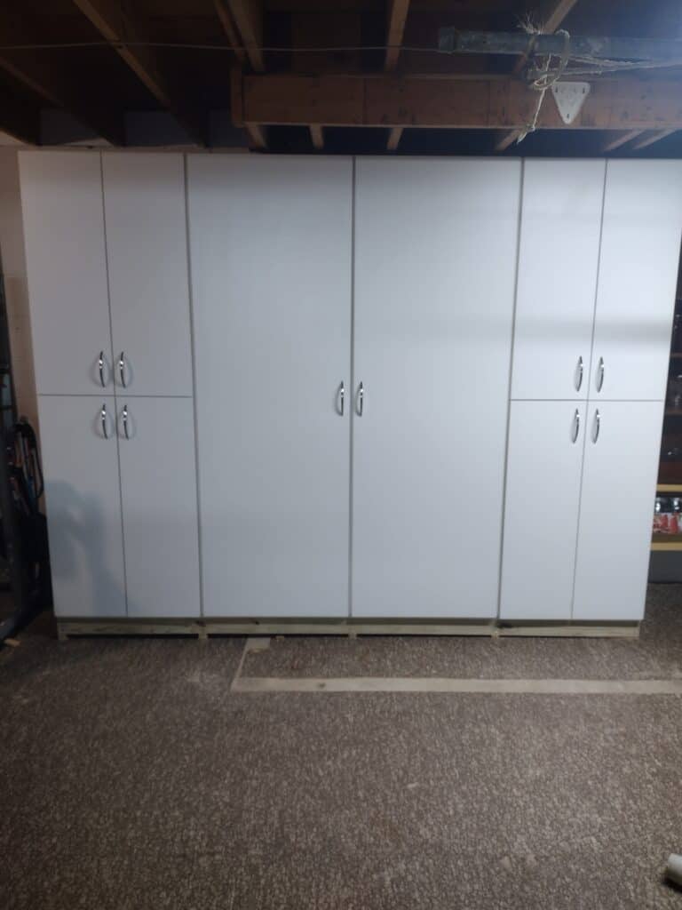 Large white closet storage cabinet with multiple doors for organized clothing and accessories.