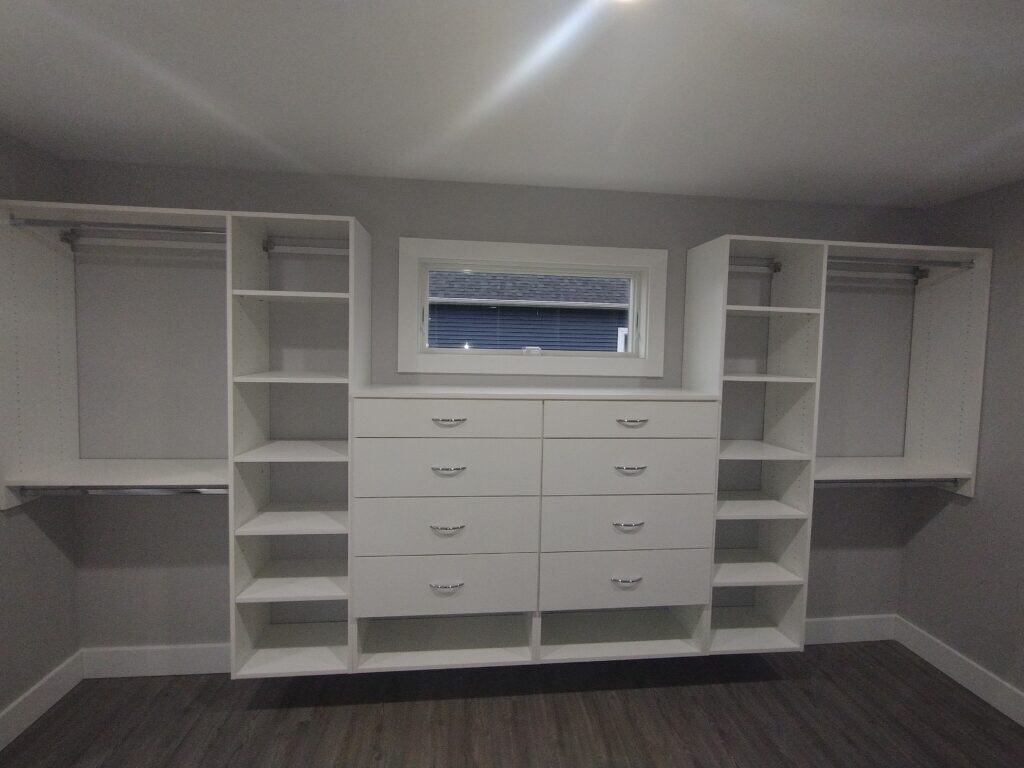 Custom walk-in closet with multiple shelves and hanging rods.