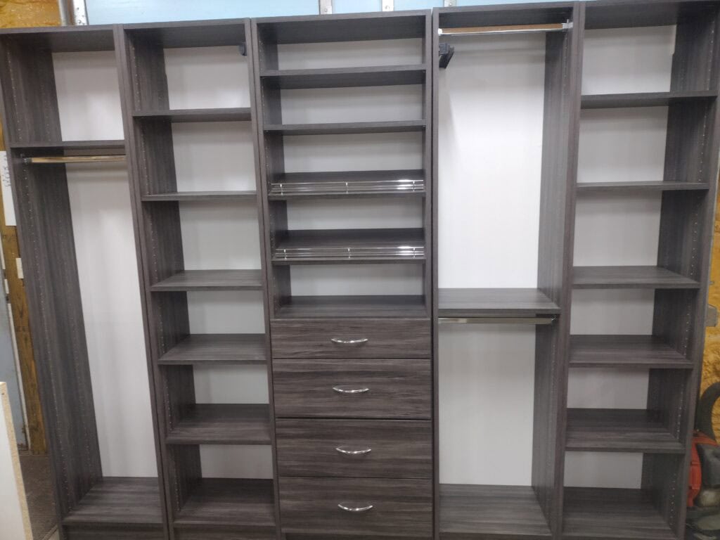 Custom closet organization with multiple shelves and drawers for efficient storage.
