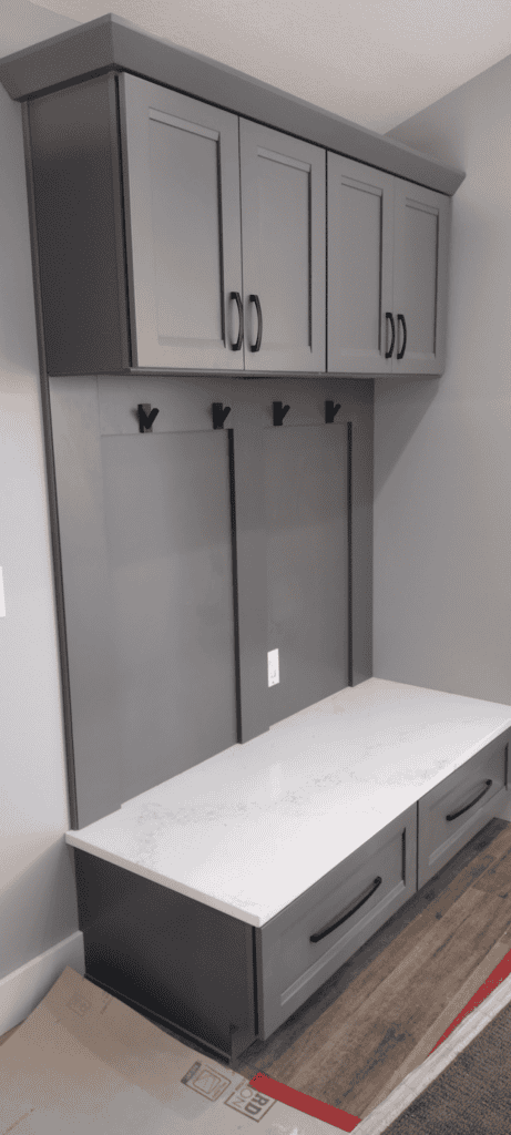 Custom gray closet with upper cabinets and a spacious countertop for organized storage solutions.